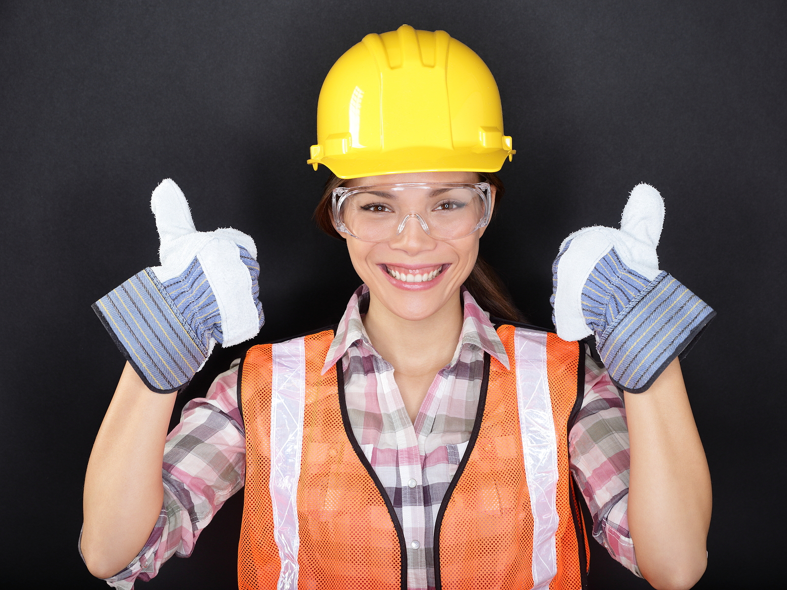 Construction worker happy woman doing thumbs up with protection