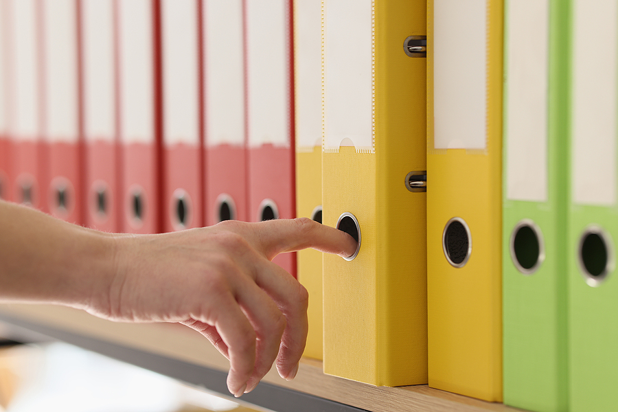 Hand Of Secretary Taking Yellow Ring Binder With Documents. Orga