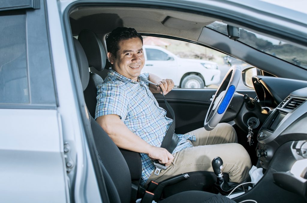 bigstock Smiling Male Driver Putting On 461492829