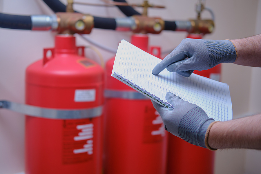 The Inspector Of Fire Security Is Using His Notepad To Jot Down