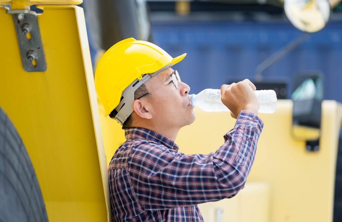 Worker Man In Hard Hat Drinking Water At Containers Cargo